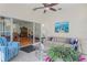 Open living room with tile floors, sliding glass doors to another room, and comfortable furnishings at 11250 Hollander Ave, Hudson, FL 34667
