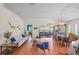 Bright living room and dining area with wood floors, stylish furniture, and sliding glass doors at 11250 Hollander Ave, Hudson, FL 34667