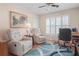 Home office featuring comfortable chairs, a window with shutters, and a workspace at 11250 Hollander Ave, Hudson, FL 34667