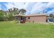 Spacious backyard with well maintained lawn, screened lanai, and plenty of room for entertaining at 11396 Terrell Rd, Spring Hill, FL 34608