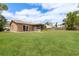 Spacious backyard with well maintained lawn, screened lanai, and plenty of room for entertaining at 11396 Terrell Rd, Spring Hill, FL 34608