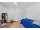 Cozy bedroom with hardwood floors, single bed with blue covers, and ample natural light at 11396 Terrell Rd, Spring Hill, FL 34608