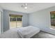 Bright bedroom with a ceiling fan, large window, and sliding glass door with backyard access at 11396 Terrell Rd, Spring Hill, FL 34608