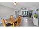 Bright dining room features wood table, hardwood floors, and modern lighting and fan at 11396 Terrell Rd, Spring Hill, FL 34608