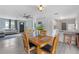 Inviting dining area with wooden table set, opening to a cozy living room with modern gray flooring at 11396 Terrell Rd, Spring Hill, FL 34608
