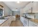 Updated kitchen with white cabinets, modern appliances, and view to dining area at 11396 Terrell Rd, Spring Hill, FL 34608