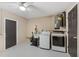 Functional laundry room equipped with modern washer, dryer, and utility sink at 11396 Terrell Rd, Spring Hill, FL 34608