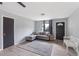 Cozy living room features grey sofa, dark grey rug, and neutral wall paint at 11396 Terrell Rd, Spring Hill, FL 34608