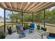 Enclosed patio features cushioned seating, glass table, and view of the spacious backyard at 11396 Terrell Rd, Spring Hill, FL 34608