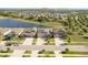 A wide, scenic aerial view of a neighborhood with a pond and beautiful homes that are neatly arranged along the streets at 11407 Acacia Grove Ln, Riverview, FL 33579