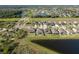 A picturesque aerial view of a residential neighborhood with pristine landscaping and serene lakes at 11407 Acacia Grove Ln, Riverview, FL 33579