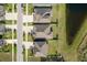 Overhead shot of symmetrical homes with clean driveways and well-maintained lawns, adjacent to a natural pond feature at 11407 Acacia Grove Ln, Riverview, FL 33579