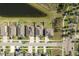 Birds-eye view of single Gathering homes, showcasing rooftops, driveways, and landscaping alongside a scenic pond at 11407 Acacia Grove Ln, Riverview, FL 33579