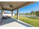 Relaxing screened back porch with serene water views and comfortable seating area at 11407 Acacia Grove Ln, Riverview, FL 33579