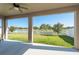 Relaxing screened back porch with a serene view of the water and lush green backyard at 11407 Acacia Grove Ln, Riverview, FL 33579