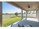 Relaxing screened back porch with serene water views and lush green backyard at 11407 Acacia Grove Ln, Riverview, FL 33579