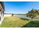 Well maintained back yard with white fence and water view at 11407 Acacia Grove Ln, Riverview, FL 33579