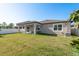 Well maintained back yard with white fence and water view, accessible from back porch at 11407 Acacia Grove Ln, Riverview, FL 33579