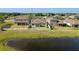 Beautiful backyard featuring a white fence, green grass, and a calming pond view at 11407 Acacia Grove Ln, Riverview, FL 33579