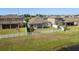 Well-maintained fenced backyard with a covered patio and tranquil pond views for outdoor enjoyment at 11407 Acacia Grove Ln, Riverview, FL 33579