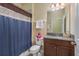 Bathroom featuring granite vanity, shower with curtain, and modern fixtures at 11407 Acacia Grove Ln, Riverview, FL 33579