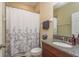 Well-lit bathroom with granite vanity, framed mirror, and shower/tub combination at 11407 Acacia Grove Ln, Riverview, FL 33579