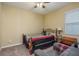 Cozy bedroom with ceiling fan and natural light with attached small sofa at 11407 Acacia Grove Ln, Riverview, FL 33579