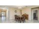 Formal dining area with a chandelier, wood table and chairs, and tile flooring at 11407 Acacia Grove Ln, Riverview, FL 33579