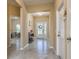 Inviting entryway with tile floors, a decorative front door, and convenient shoe rack, creating a welcoming space at 11407 Acacia Grove Ln, Riverview, FL 33579