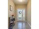 Bright and welcoming entryway featuring a decorative front door, tile flooring, and space for shoe storage at 11407 Acacia Grove Ln, Riverview, FL 33579