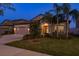 Charming home with a well-kept lawn, a two-car garage and appealing landscaping at 11407 Acacia Grove Ln, Riverview, FL 33579
