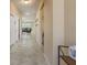 Spacious hallway with tile flooring leading to the living area, showcasing the home's open layout at 11407 Acacia Grove Ln, Riverview, FL 33579