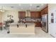 Bright kitchen with a granite island, stainless steel appliances, and stylish dark wood cabinetry at 11407 Acacia Grove Ln, Riverview, FL 33579