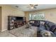 Cozy living room featuring a comfortable sofa, modern decor, and large windows for plenty of natural light at 11407 Acacia Grove Ln, Riverview, FL 33579