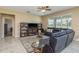 Comfortable living room features a ceiling fan, tile floors, and plenty of natural light at 11407 Acacia Grove Ln, Riverview, FL 33579
