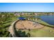A vibrant community playground next to a tranquil lake perfect for Gathering fun and recreation at 11407 Acacia Grove Ln, Riverview, FL 33579