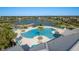 An inviting pool area surrounded by palm trees, lounge chairs, and a beautiful lakeside view at 11407 Acacia Grove Ln, Riverview, FL 33579