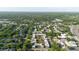 This aerial view shows the property surrounded by lush greenery and mature trees, offering a serene and private setting at 14419 Americana Cir # 103, Tampa, FL 33613
