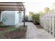 Cozy patio with brick path, lush landscaping, and a fence, offering privacy at 14419 Americana Cir # 103, Tampa, FL 33613