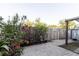 Landscaped backyard with brick pavers, blooming flowers, and a cozy outdoor setting at 14419 Americana Cir # 103, Tampa, FL 33613