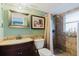 Cozy bathroom featuring a tiled shower and dark wood vanity with decorative mirror at 14419 Americana Cir # 103, Tampa, FL 33613