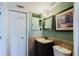 Cozy bathroom with vanity, tile backsplash, and framed mirror at 14419 Americana Cir # 103, Tampa, FL 33613