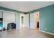 Bright bedroom with walk-in closet and ensuite bathroom, featuring tile flooring and neutral walls at 14419 Americana Cir # 103, Tampa, FL 33613