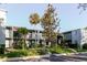 Attractive condo complex with well-maintained landscaping, lush green lawn and mature trees at 14419 Americana Cir # 103, Tampa, FL 33613