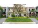 Exterior of property surrounded by a green lawn and mature trees at 14419 Americana Cir # 103, Tampa, FL 33613