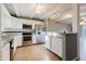 Bright kitchen featuring stainless steel appliances, granite countertops, and open layout at 14419 Americana Cir # 103, Tampa, FL 33613