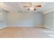Open living room featuring neutral tile flooring, ceiling fan and modern lighting at 14419 Americana Cir # 103, Tampa, FL 33613