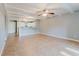 Open-concept living room and kitchen featuring neutral tile flooring and open view of the kitchen area at 14419 Americana Cir # 103, Tampa, FL 33613