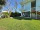 Large backyard with seating area, green grass, and mature landscaping at 16204 3Rd E St, Redington Beach, FL 33708