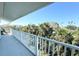 Spacious balcony overlooking lush tropical trees and foliage offering tranquility at 16204 3Rd E St, Redington Beach, FL 33708